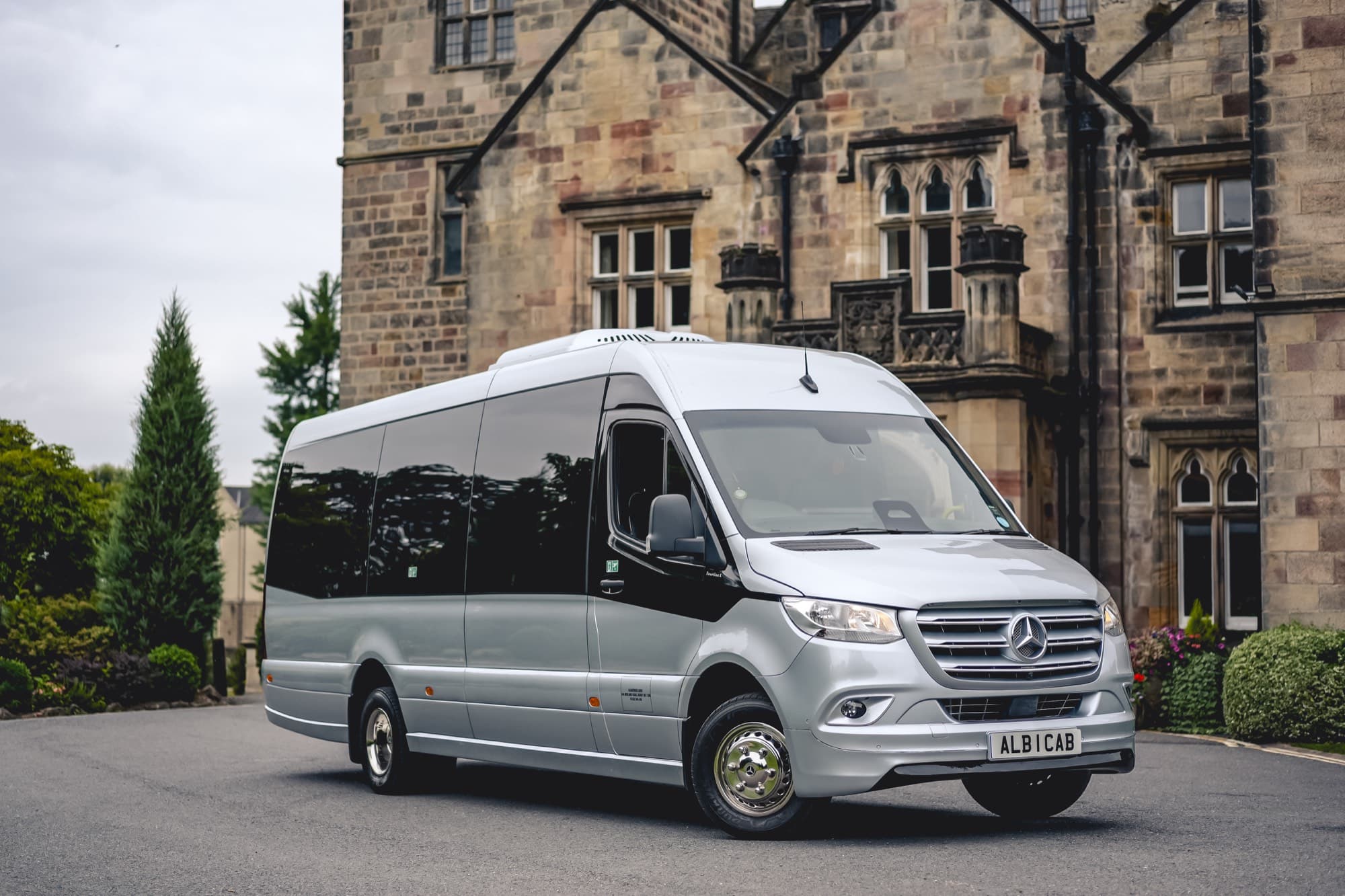 A silver Mercedes-Benz Sprinter minibus outside Breadsall Priory